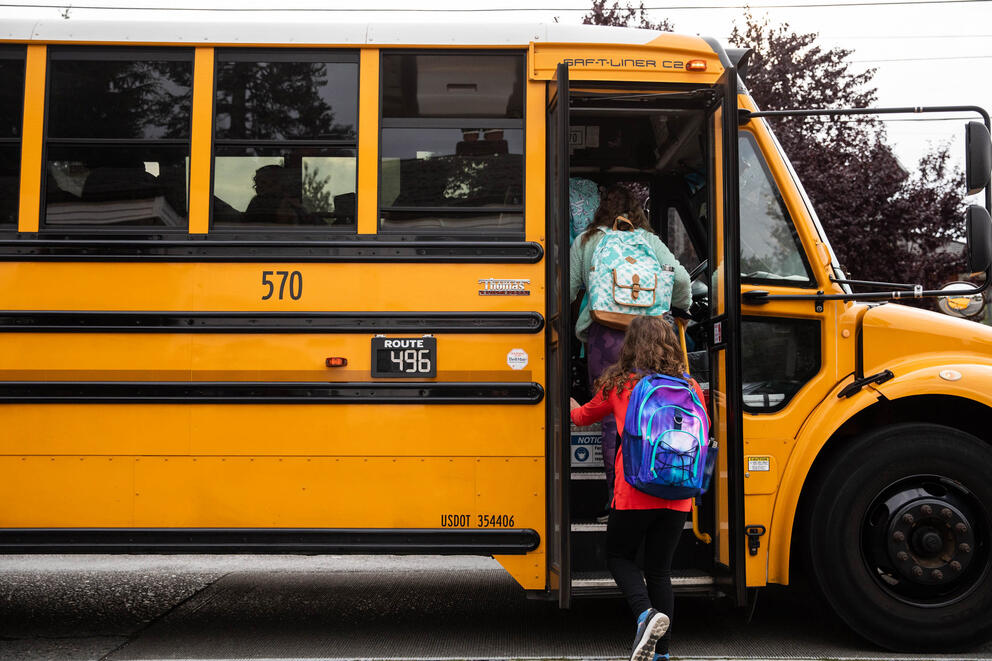 students boarding a school bus