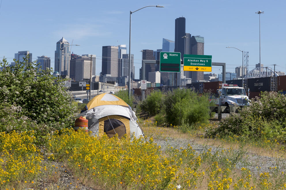  A lone tent is pitched between E Marginal Way S and Highway 99 in the Industrial District 