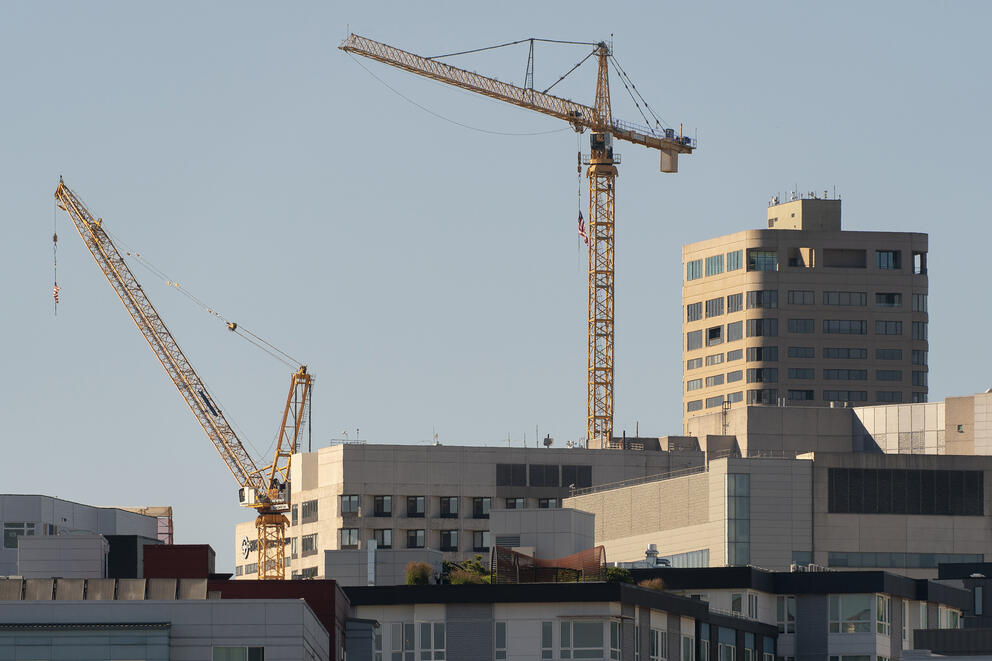 construction cranes over a building