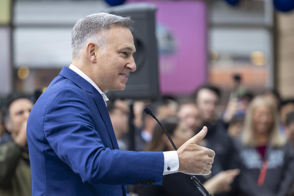 A person speaks in front of a crowd