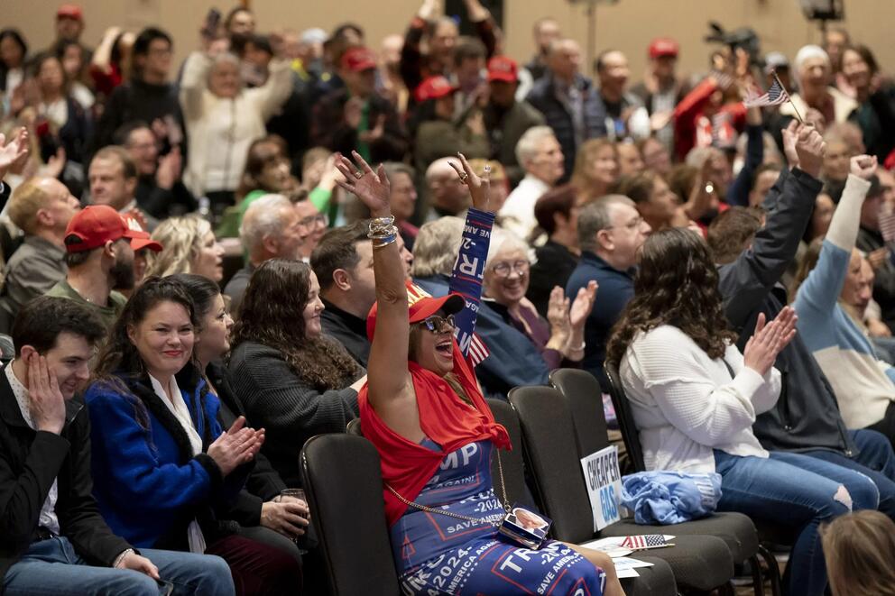 Attendee in Trump-themed outfit cheers in crowd