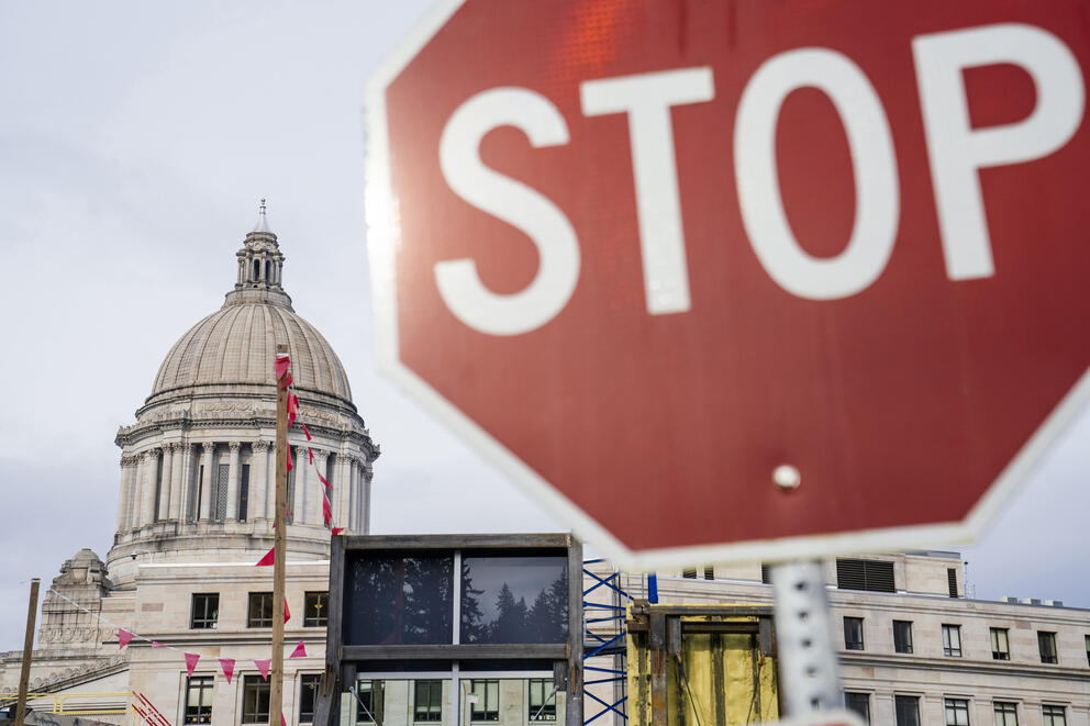 A stop sign is pictured in front of the Capitol dome in Olympia.