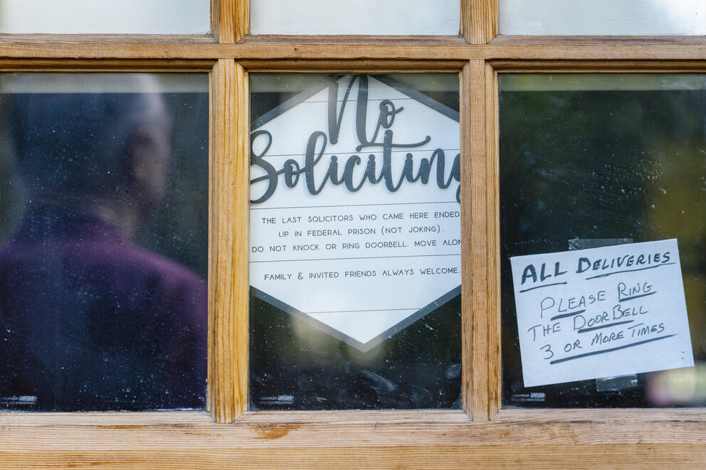 A sign in a window says: "No Soliciting. The last solicitors who came here ended up in federal prison (not joking). Do not knock or ring doorbell. Move along."