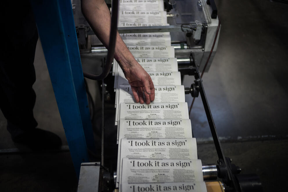 A pressman checks the press