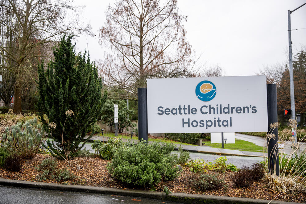 A sign on a landscaped driveway says "Seattle Children's Hospital"