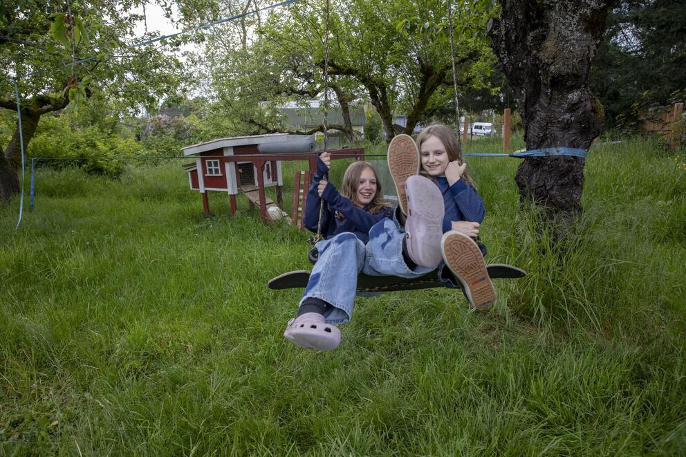 children swing in a backyard
