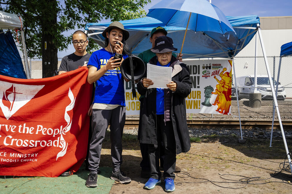 Activists read a letter outside the detention center