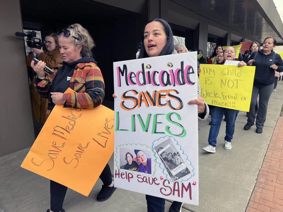 People march outside U.S. Rep. Dan Newhouse's office in Yakima