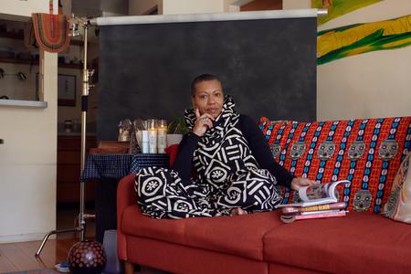 Anistaciarenee sitting on a couch in her home