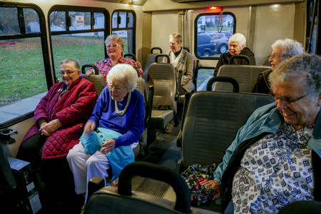 Elderly women sitting in a shuttle bus