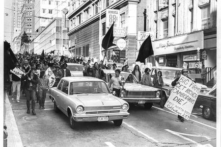 Protestors march among traffic in downtown Seattle