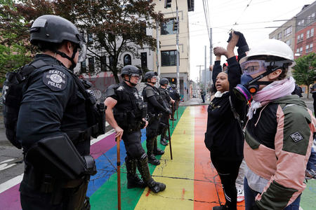 phalanx of police officers and protesters, face to face