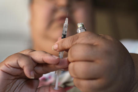 hands with syringe