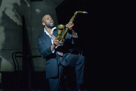 a man on stage with a saxophone