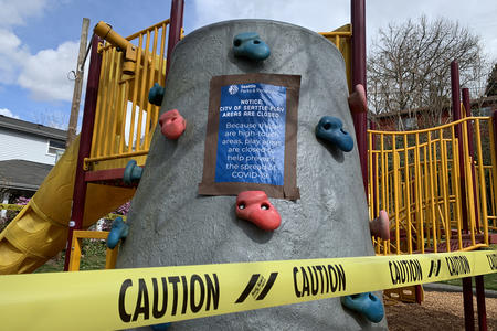 A playground shut down with caution tape