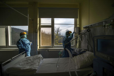 Medical staff operating a ventilator