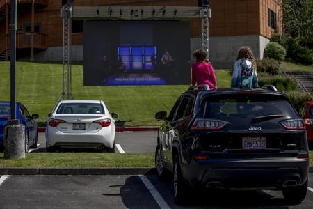 Children sit on the car roof during church