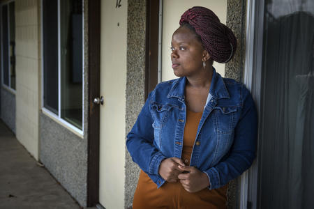 Woman standing outside her apartment