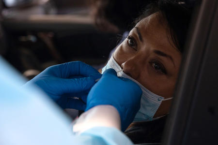 Christi Cruz, a Seattle area school teacher receives a nasopharyngeal swab test at a drive-up COVID-19 testing facility