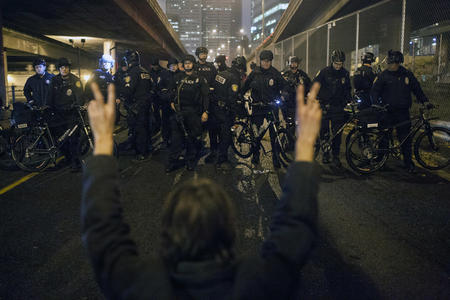 protester in front of police barricade