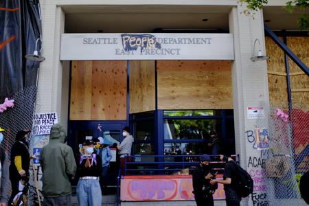 Scene in the CHOP. The word "police" in the SPD building's sign is spray painted over with the word "people