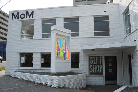 White building with neon in front