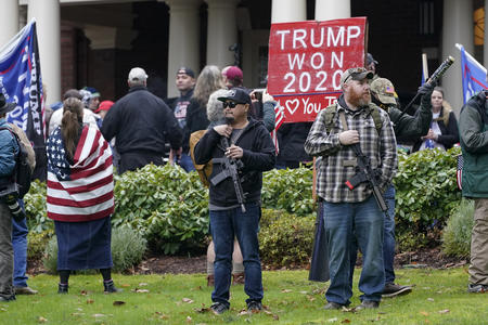 Protesters with flag, gun, bat