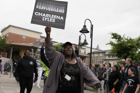 Demonstrator with “Charleena Lyles” sign