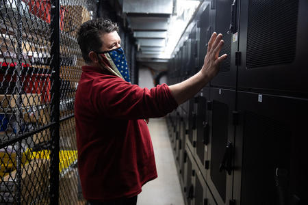 Man touches equipment in a room