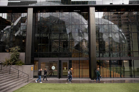Amazon Spheres are seen reflected on Day One building on Amazon's Seattle campus in South Lake Union. (Photo by Matt McKnight/Crosscut)