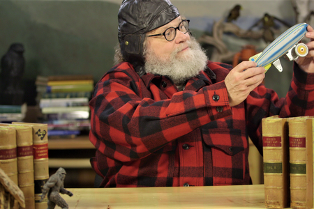 Host Knute Berger with a replica of a turn-of-the-century airship