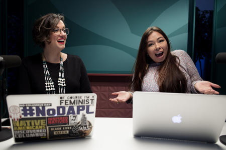 Two people using laptops
