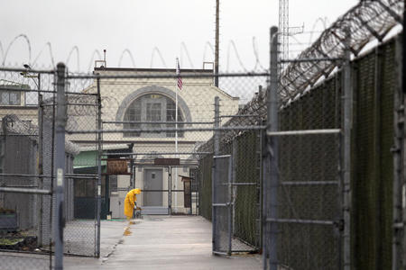 A man working outdoors at a prison