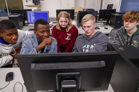 Students gathered around a computer