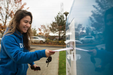 woman drops off her ballot