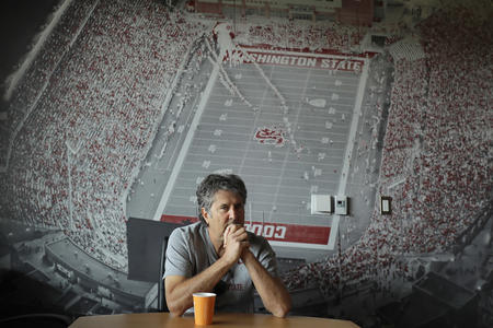 Coach Leach sitting in a conference room