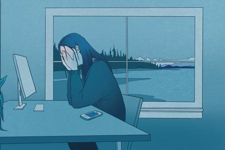 a woman at her desk with her head in her palms