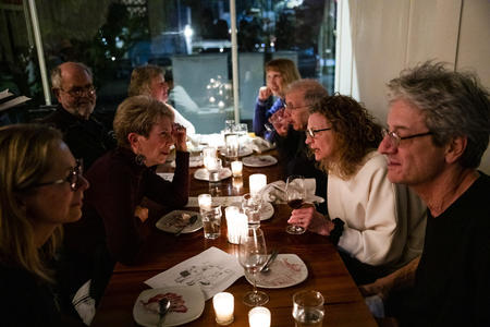 People sit around a long table at a restaurant
