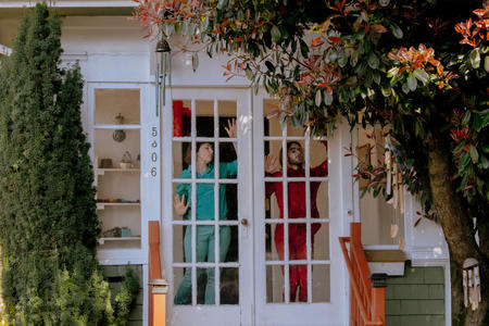 two dancers smashed up against a french door window