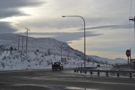 A car travels on the highway on a wintry night