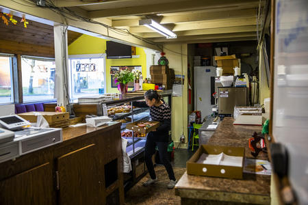 Owner Kim Sok fills a box with doughnuts at King Donuts in Rainier Beach on Sunday, Nov. 18, 2018. Sok and her family took on the business and reopened in January.