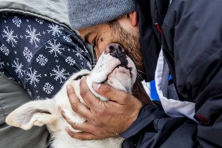 Musher kissing dog nose