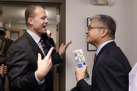 Tim Eyman speaks to Gary Locke at an October 2018 event put on by I-1000 supporters.