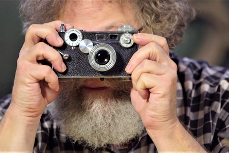 Knute Berger looks through the camera that captured President Kennedy's 1961 secret visit to the unfinished Space Needle