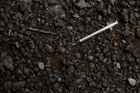 A needle found on the ground in a parking lot in Seattle's SoDo neighborhood, June 4, 2018. (Matt M. McKnight/Crosscut)