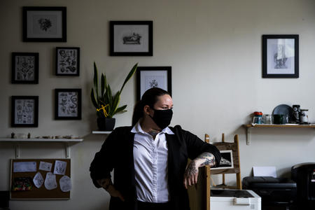Tattoo artist Jessica Henry stands inside Lilith Tattoo