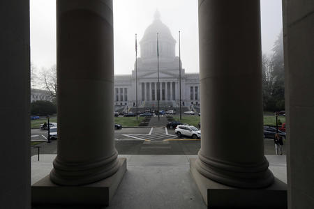 The columns of the Temple of Justice in the foreground frame a view of the state Legislative Building in the distance.