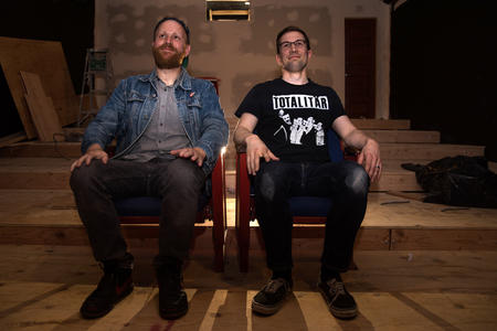 Tommy Swenson and Casey Moore sit beside eachother. 