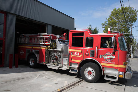 A fire truck exits a fire station.