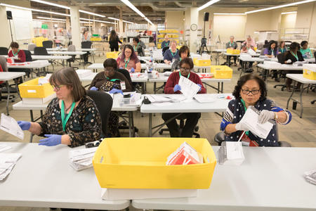 King County Elections employees check ballots